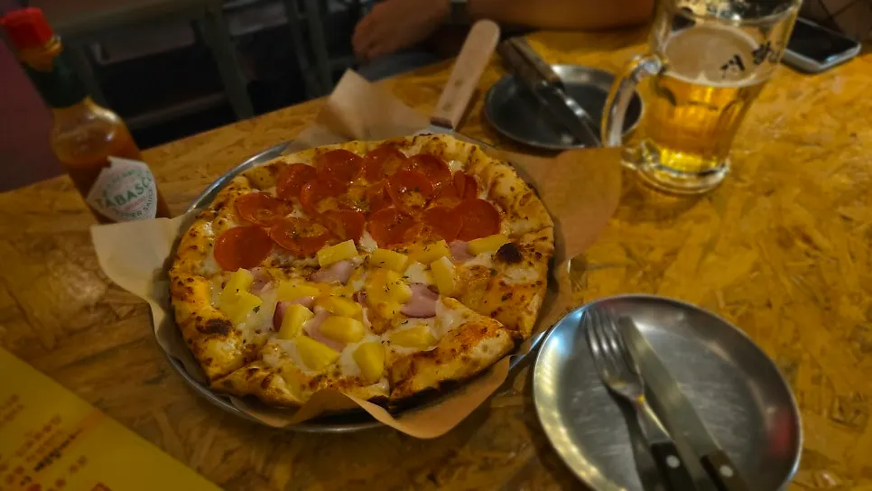 Half-eaten pizza with beer glasses