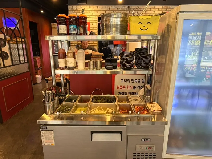 Self-serve bar with side dishes and vegetables