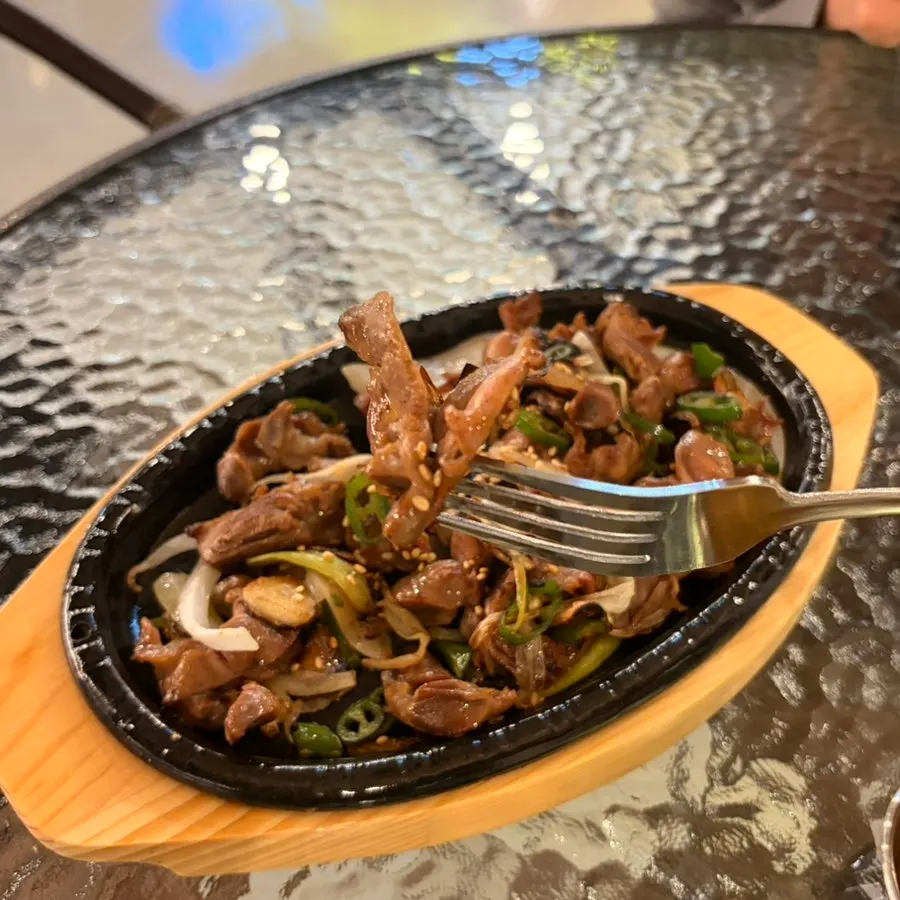A bite of spicy gizzards with chili peppers at Dalbitgwangjang