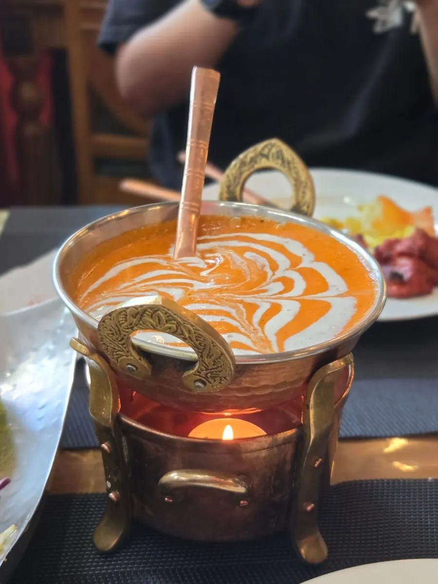 Large chunks of chicken inside the butter curry