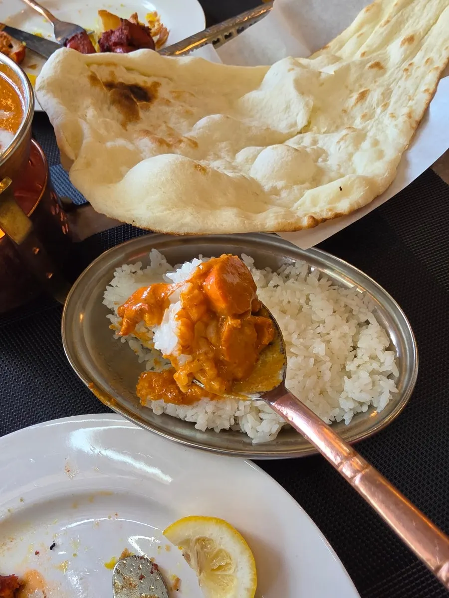 A spoonful of rice soaked with curry