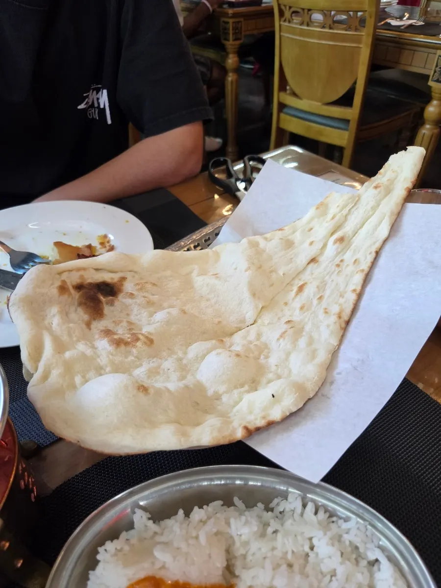 Freshly baked, generously sized plain naan