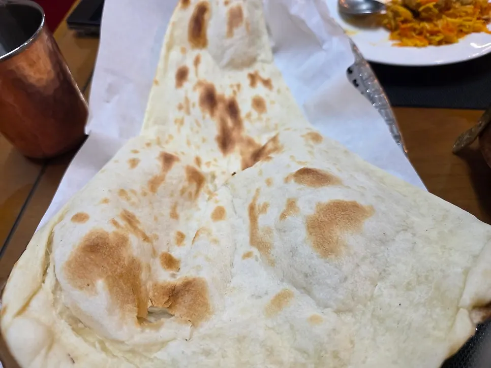 A large piece of naan for dipping into curry