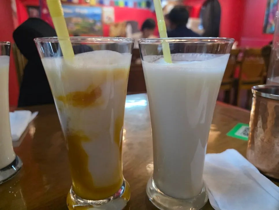 Yogurt-based lassi served alongside the Indian food spread