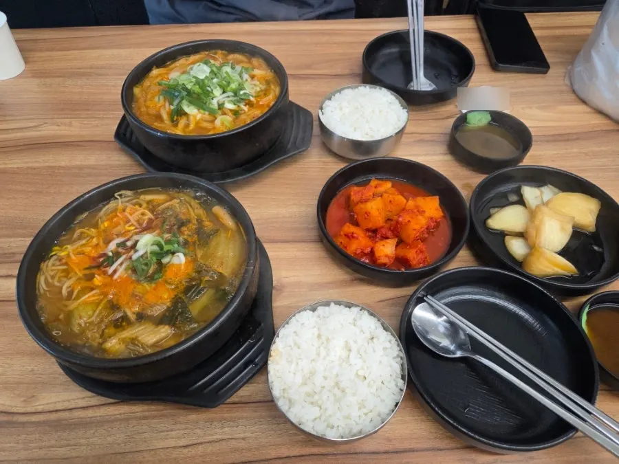 Two steaming bowls of haejangguk set on the table