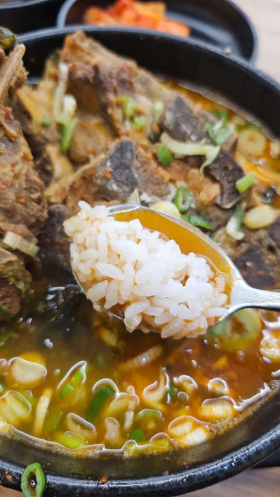 Spicy bone haejangguk broth with a bowl of rice