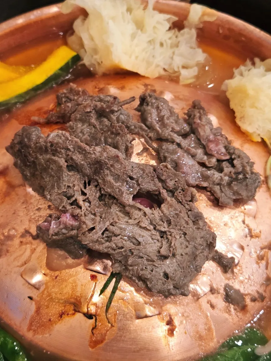 A meal of bulgogi with shallow broth