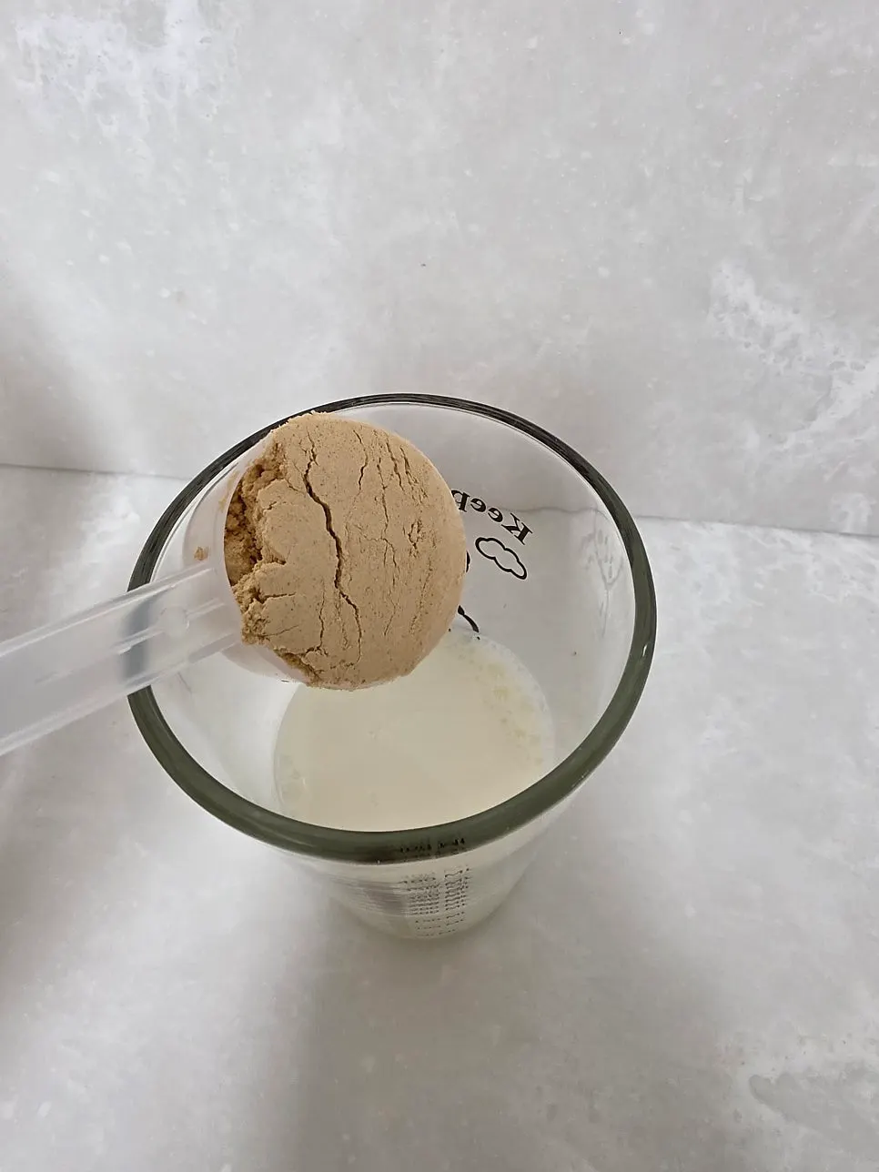Stirring the mixture with a scoop to make an injeolmi latte