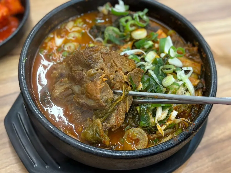 Three large chunks of bone in the spicy broth