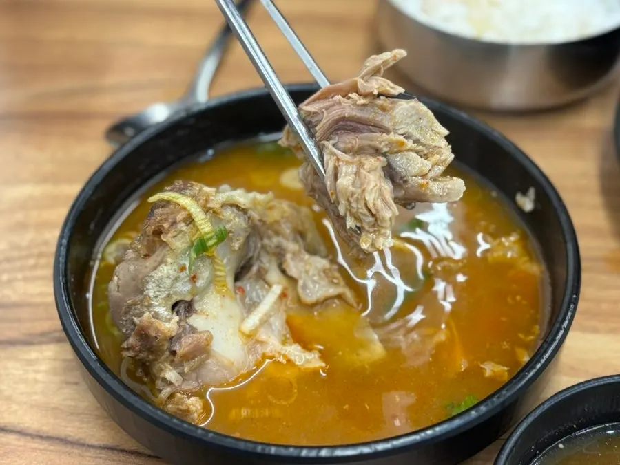 Soft meat pulled apart with chopsticks