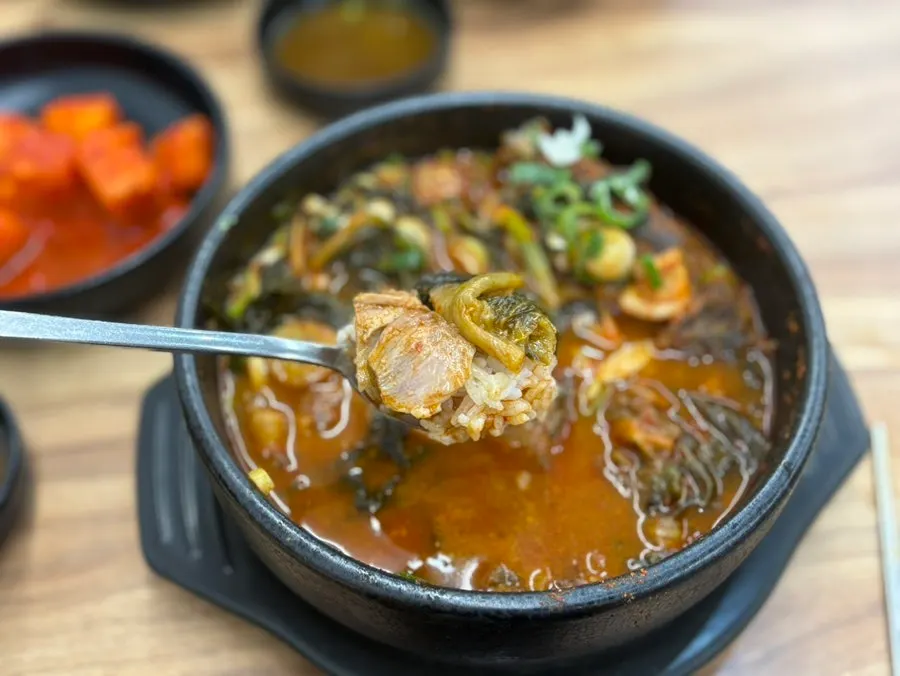 A spoonful of white rice, ugeoji, and meat