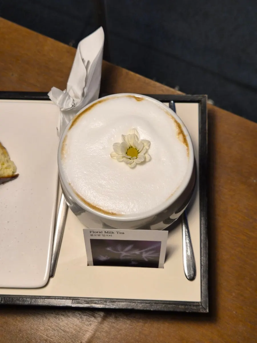 A glass of floral milk tea on the table