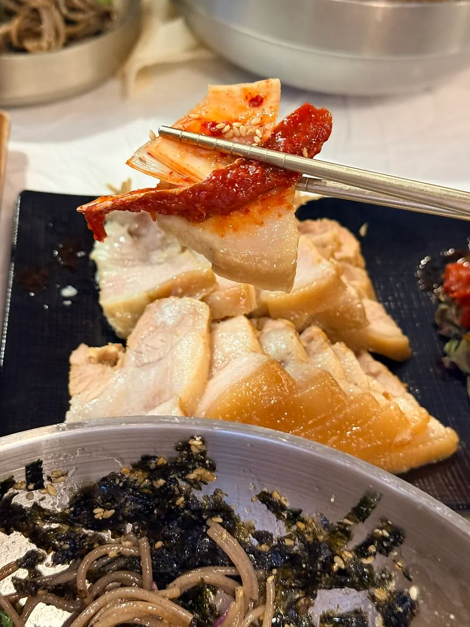 Table spread with bossam and skate salad