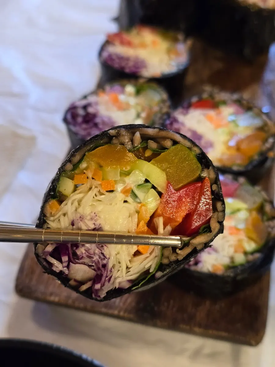 Cross-section of buckwheat gimbap packed with salad filling
