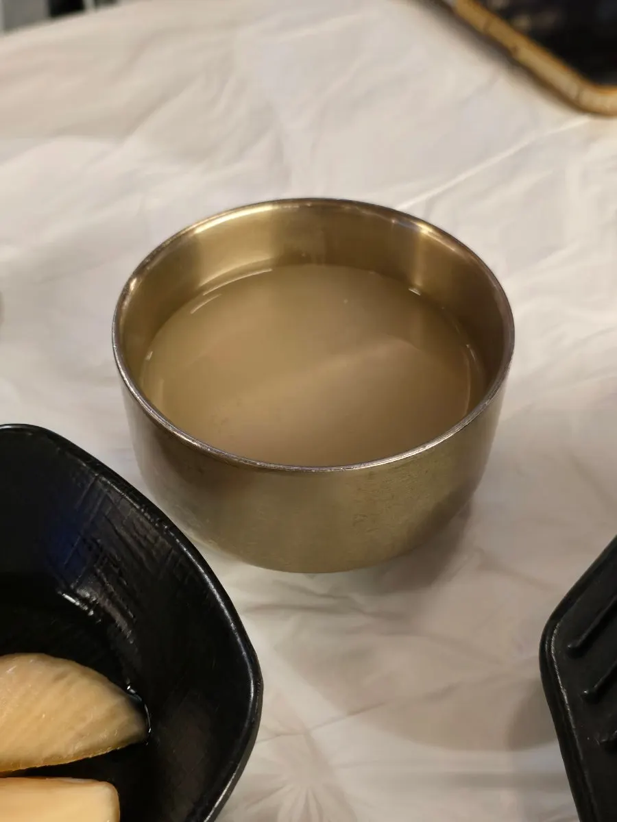 Warm broth served in a small cup