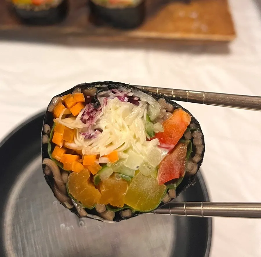 Buckwheat gimbap served with side dishes on the table