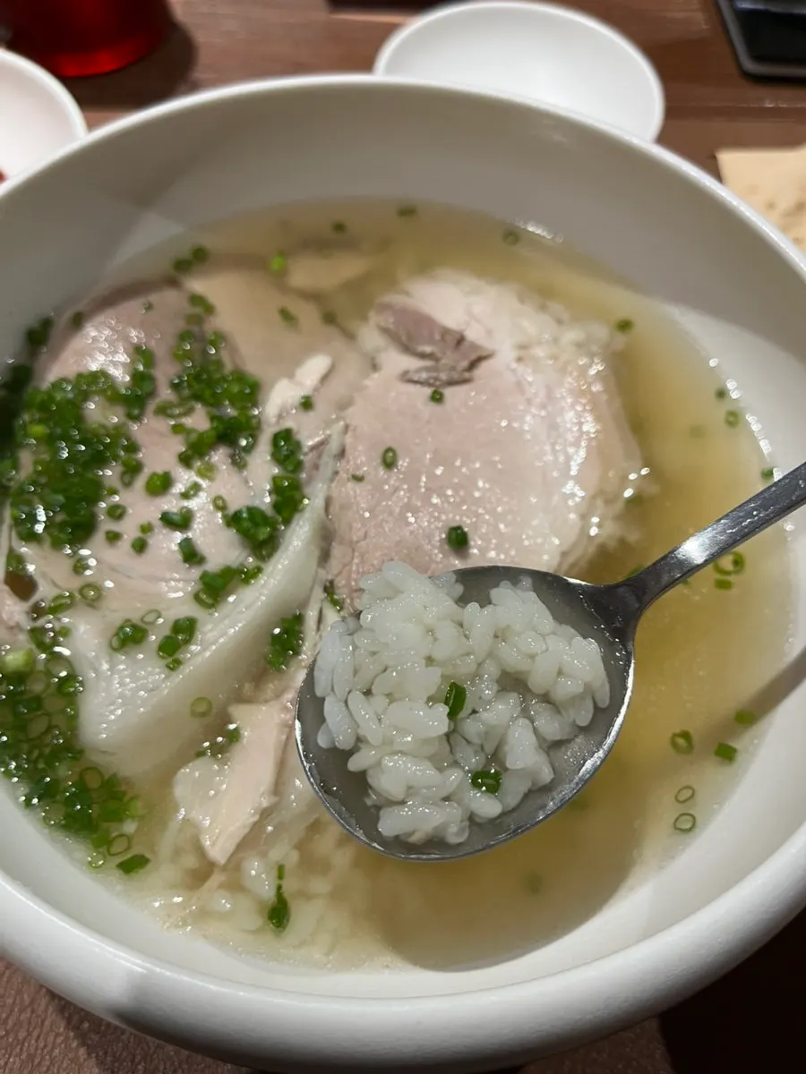 A spoonful of gomtang with meat and rice together