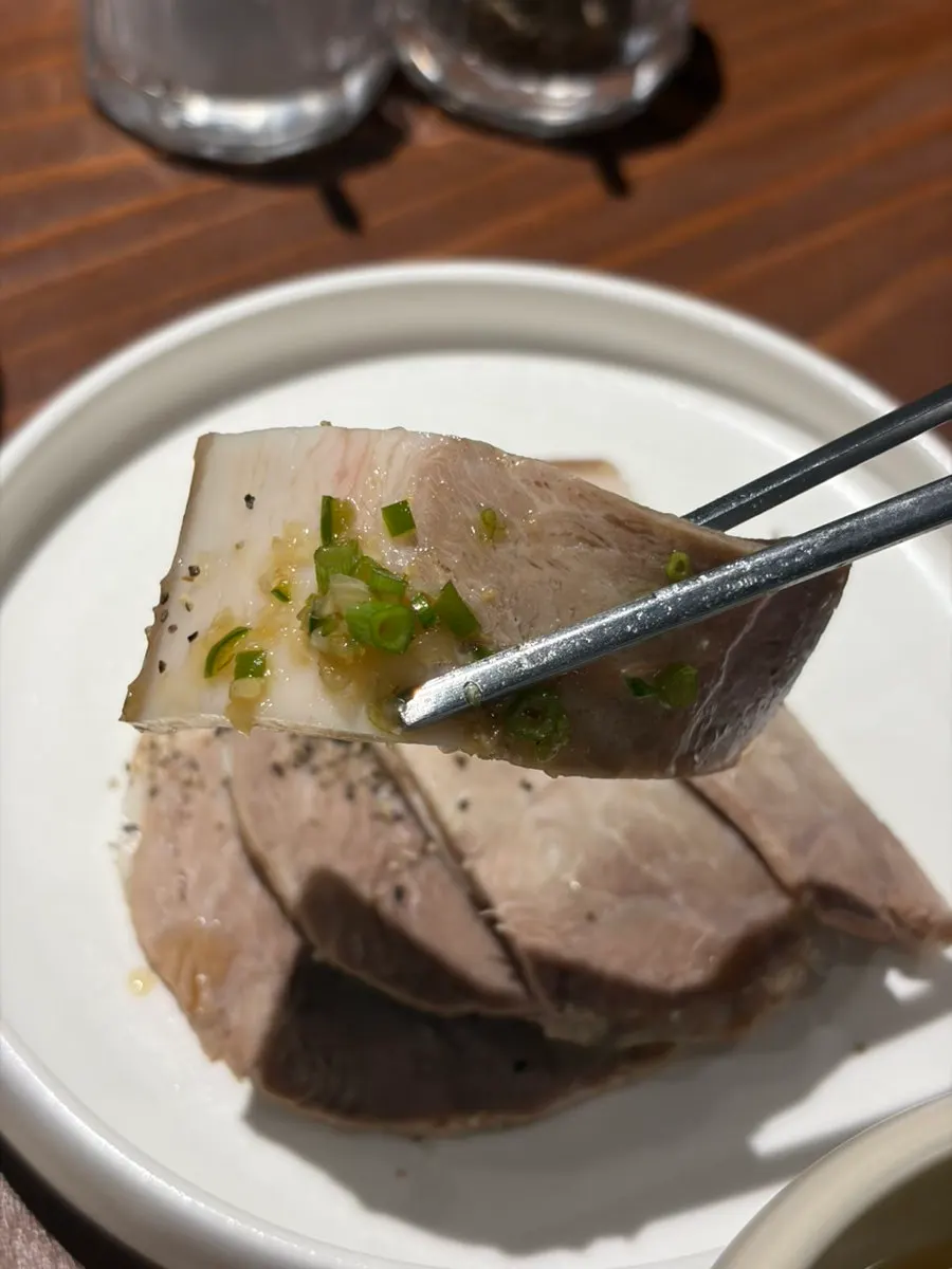 Cold jeyuk dipped in sauce