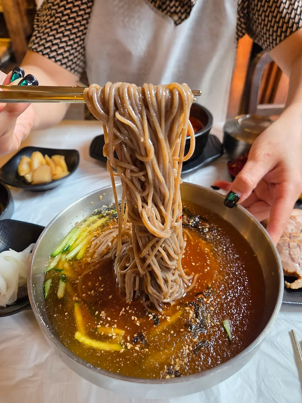Bowl of mul-makguksu with kelp and soy sauce-based broth