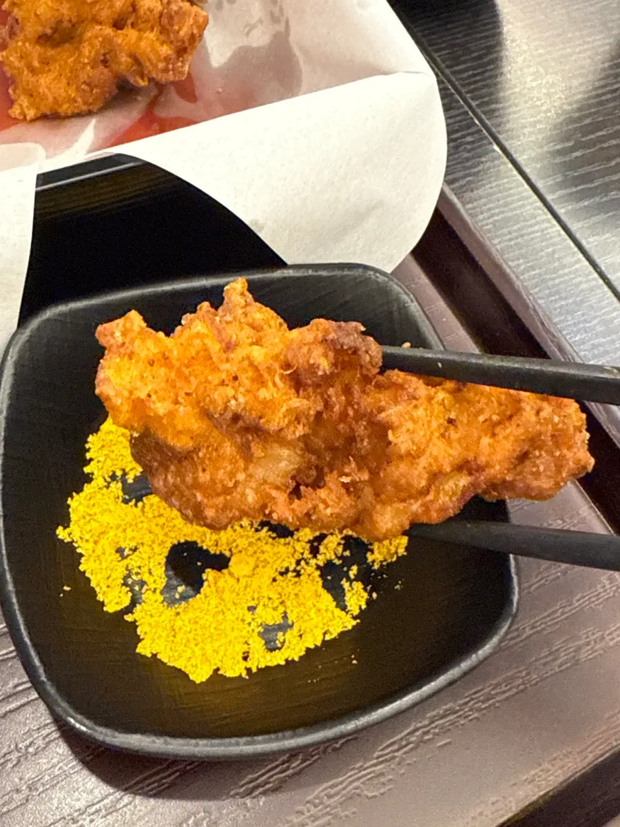 Dipping karaage into curry powder