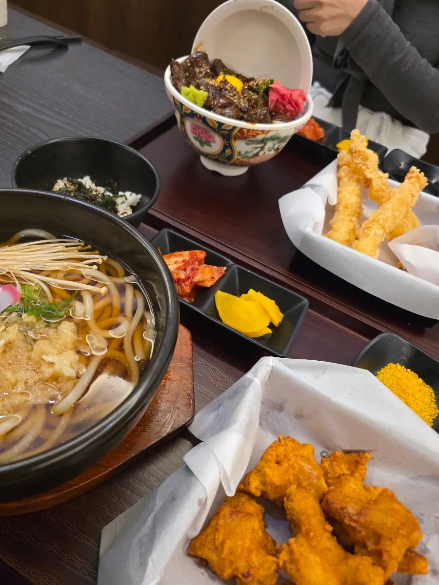 Udon noodles lifted with chopsticks