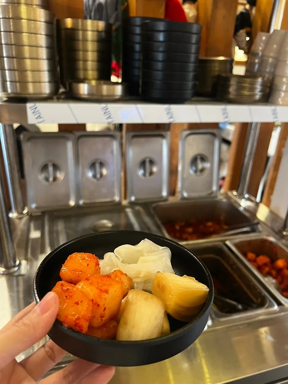 Kimchi side dishes at the self-serve bar