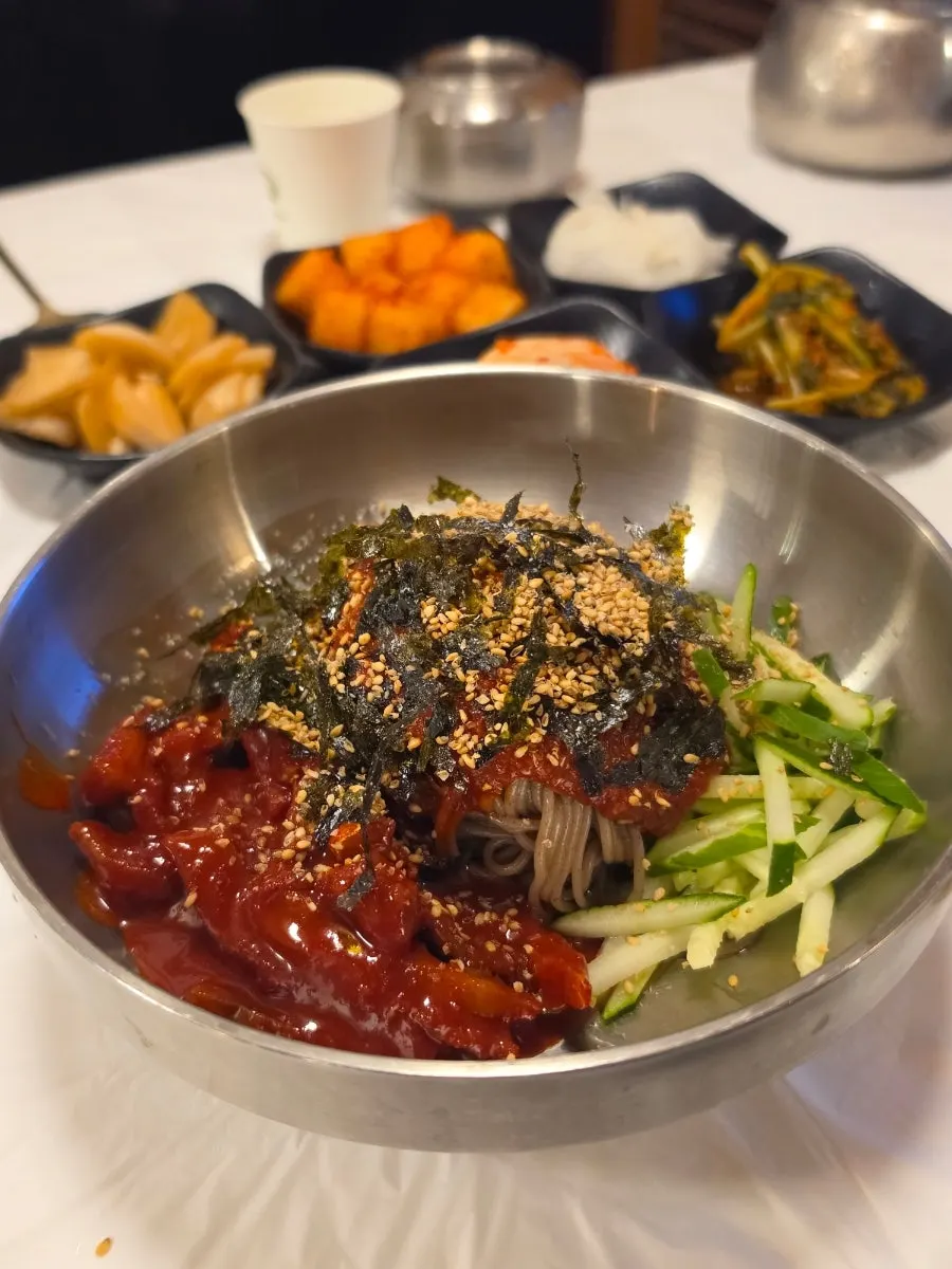 Hoe-makguksu topped with pollock jeotgal