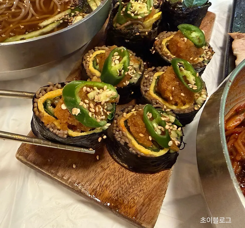 Cross-section of buckwheat gimbap topped with green chili