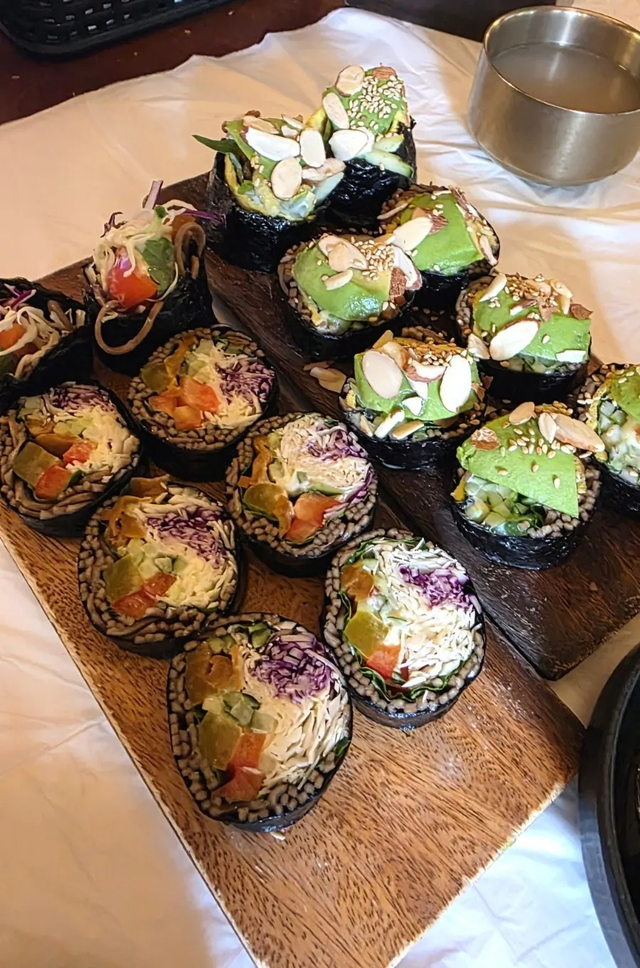 Table setting with salad buckwheat gimbap and avocado gimbap