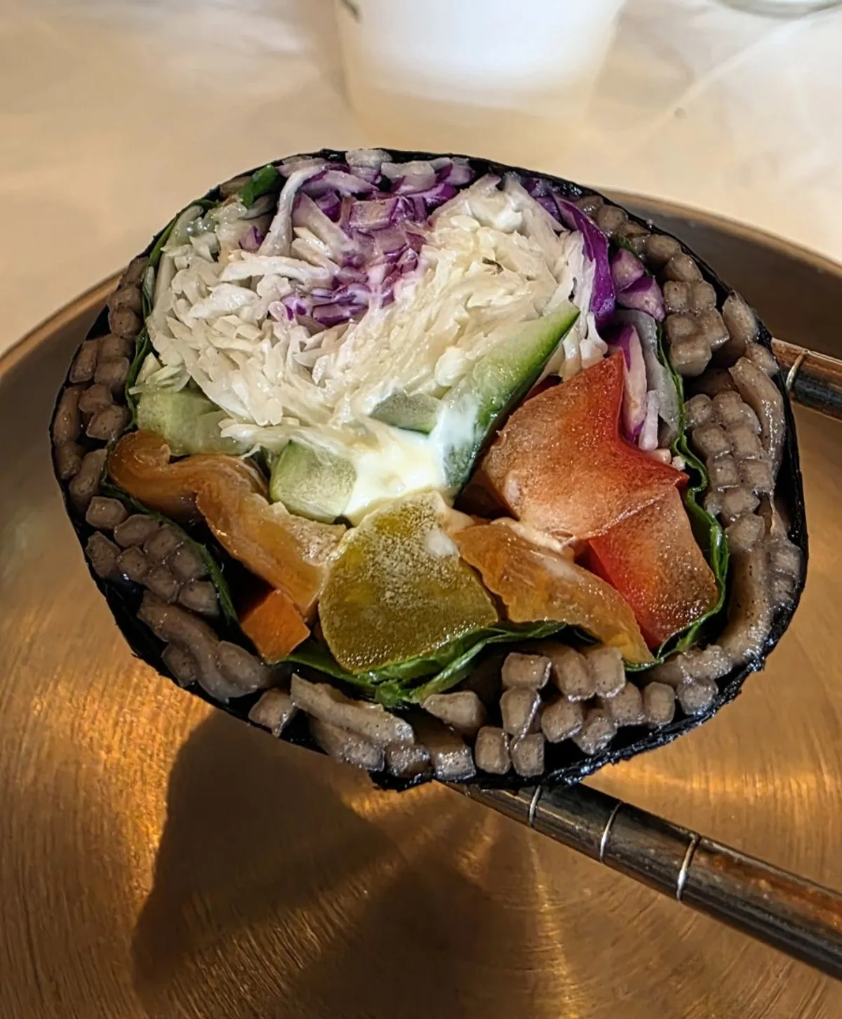 Cross-section of avocado gimbap wrapped in buckwheat noodles