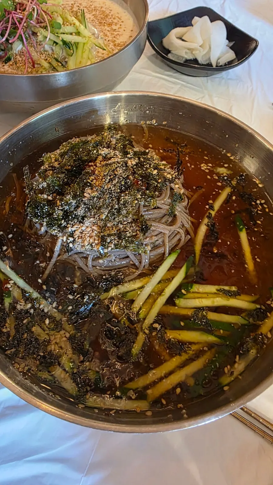 Cool mul-makguksu topped with sesame seeds