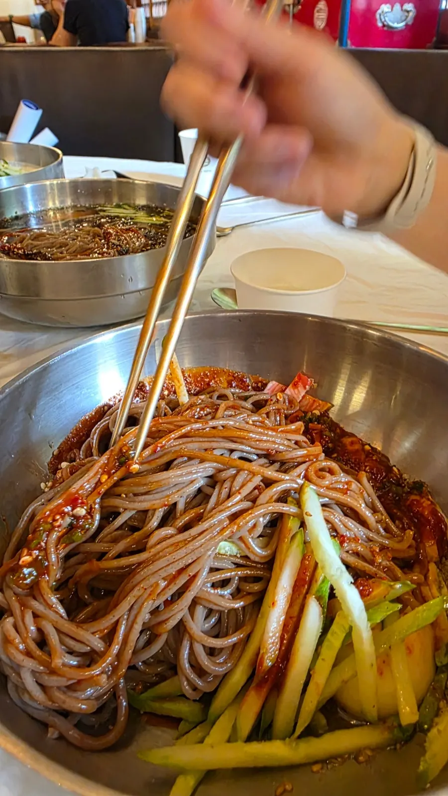 A chopstickful of mixed bibim-makguksu