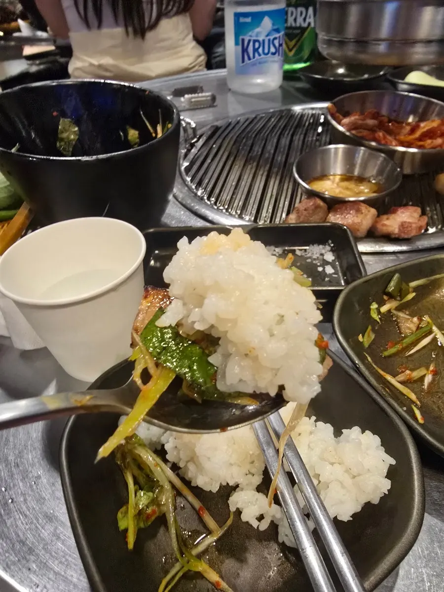 Second round of grilled meat with a bowl of rice
