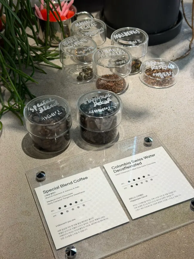 Special blend and decaf beans placed next to the menu board