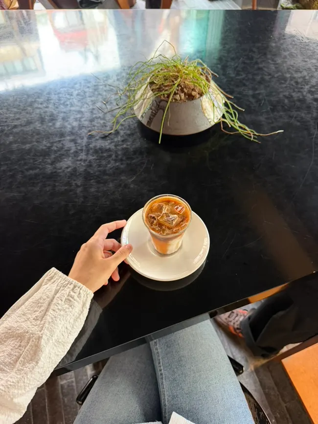 Drinking the signature Iridescent latte
