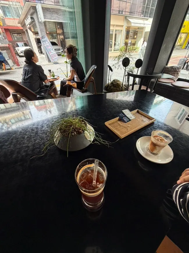 Looking out the window at Iridescent while drinking coffee
