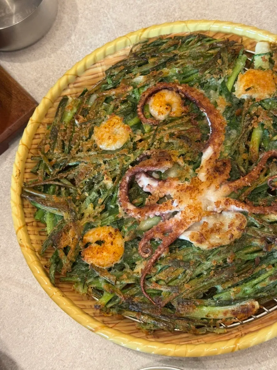 Seafood pancake topped with a whole octopus