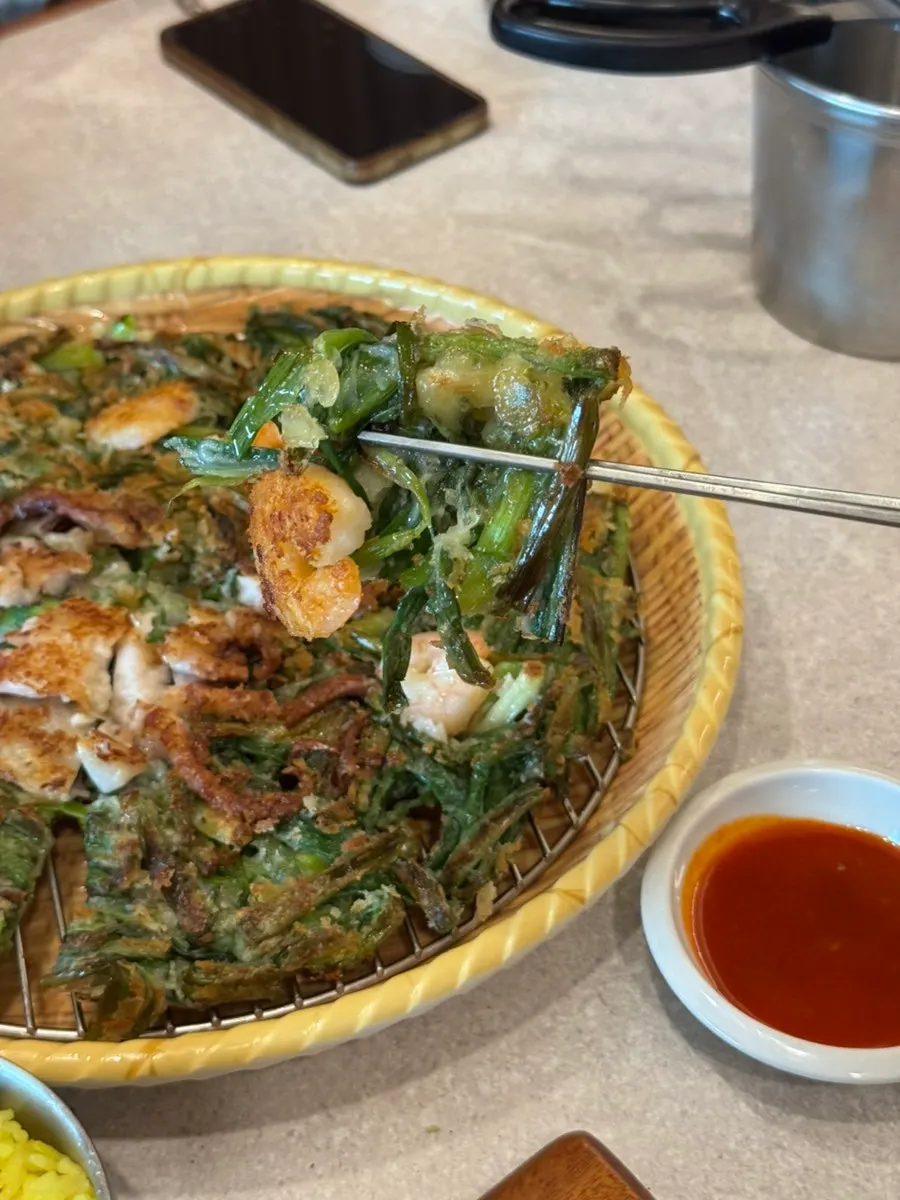 A bite of octopus seafood pancake dipped in chojang sauce