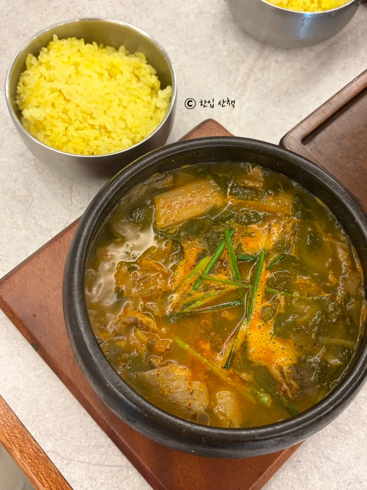 Bowl of sanghwang black goat soup with a spicy broth