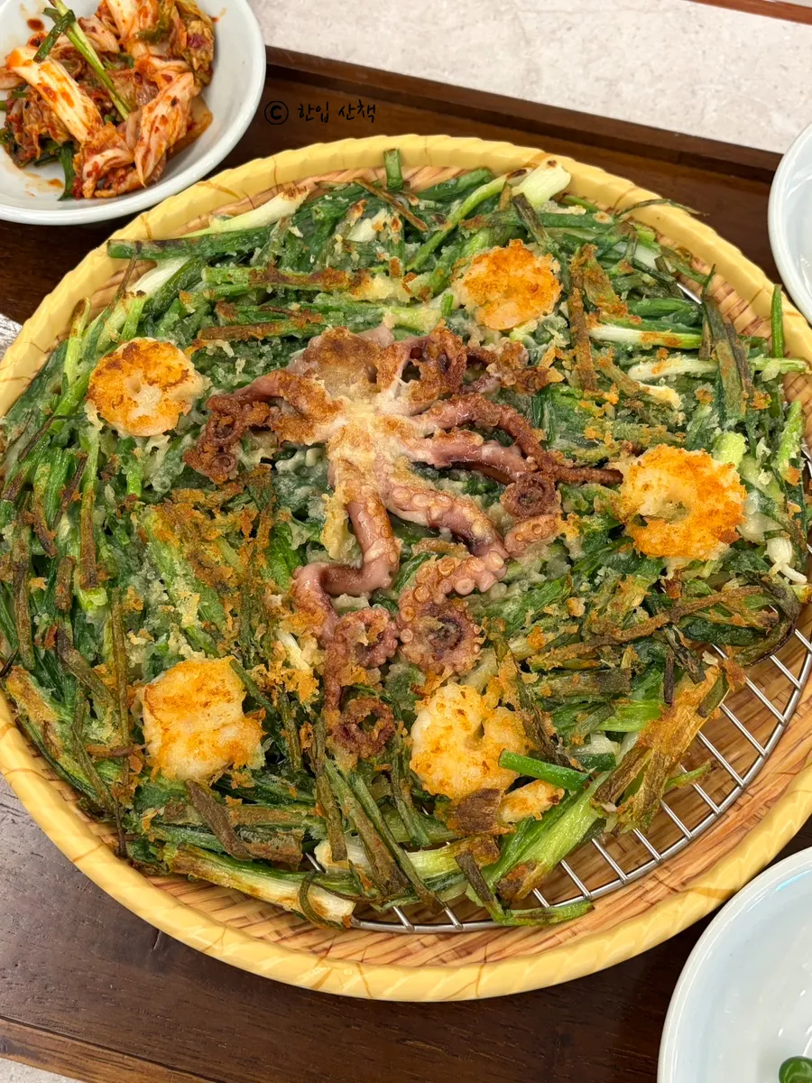 Seafood pancake topped with a whole octopus