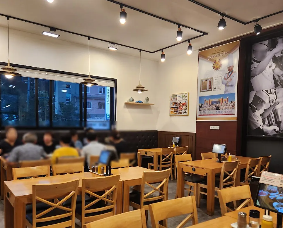 Dining hall seating with wide table spacing at Iseol Myeonok