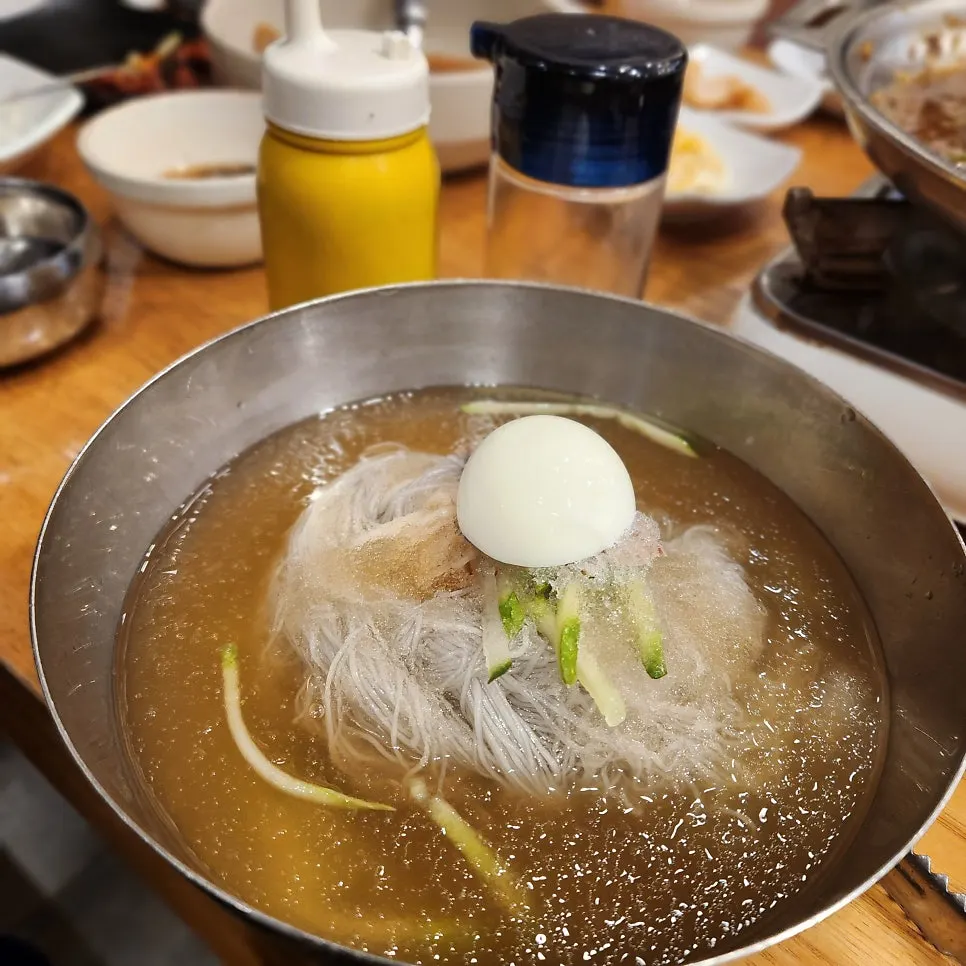 Mul naengmyeon broth with a layer of ice and noodles