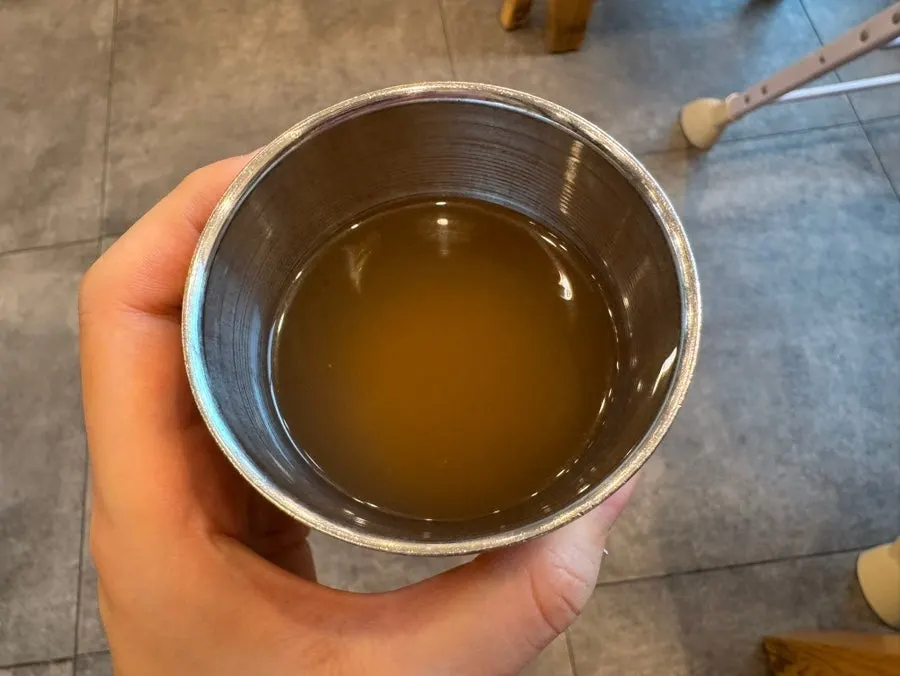 Warm broth served before the meal