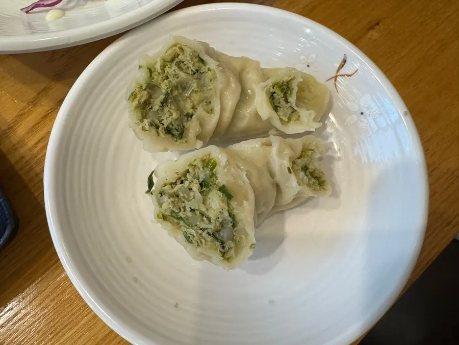 Wang mandu cut in half showing the filling