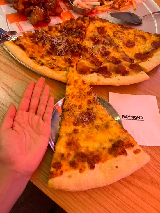 Pizza slice larger than a palm