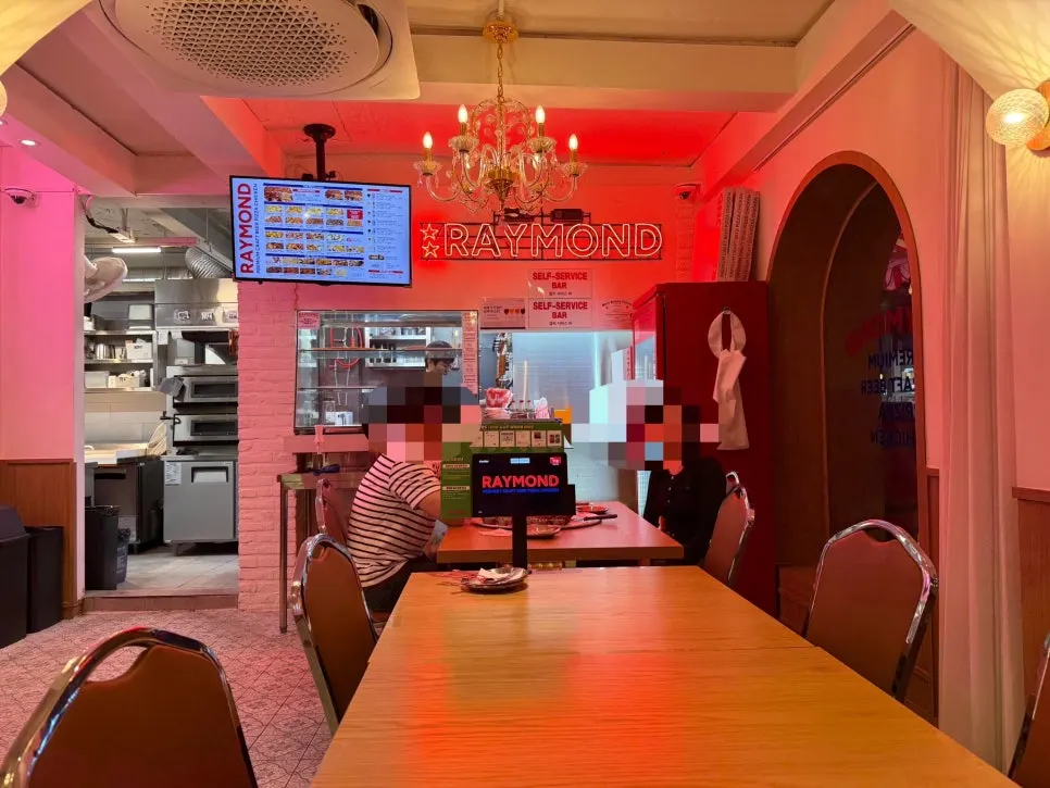 Triangular pizza boxes on display inside the restaurant