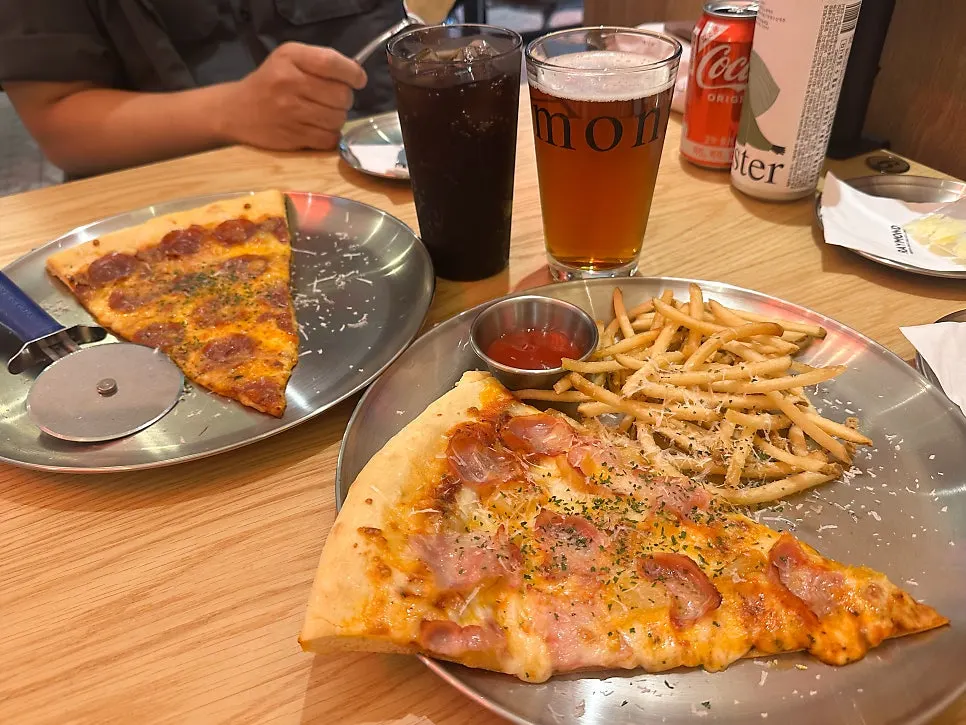 Large pizza slices and craft ale beer