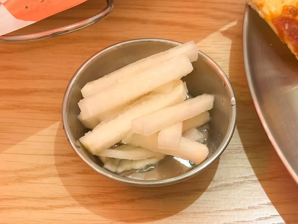 Stick-shaped pickled radish served with the chicken