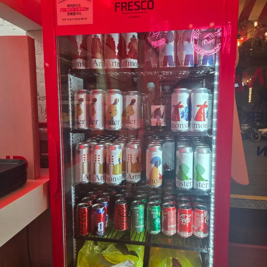 A craft beer glass set beside the pizza