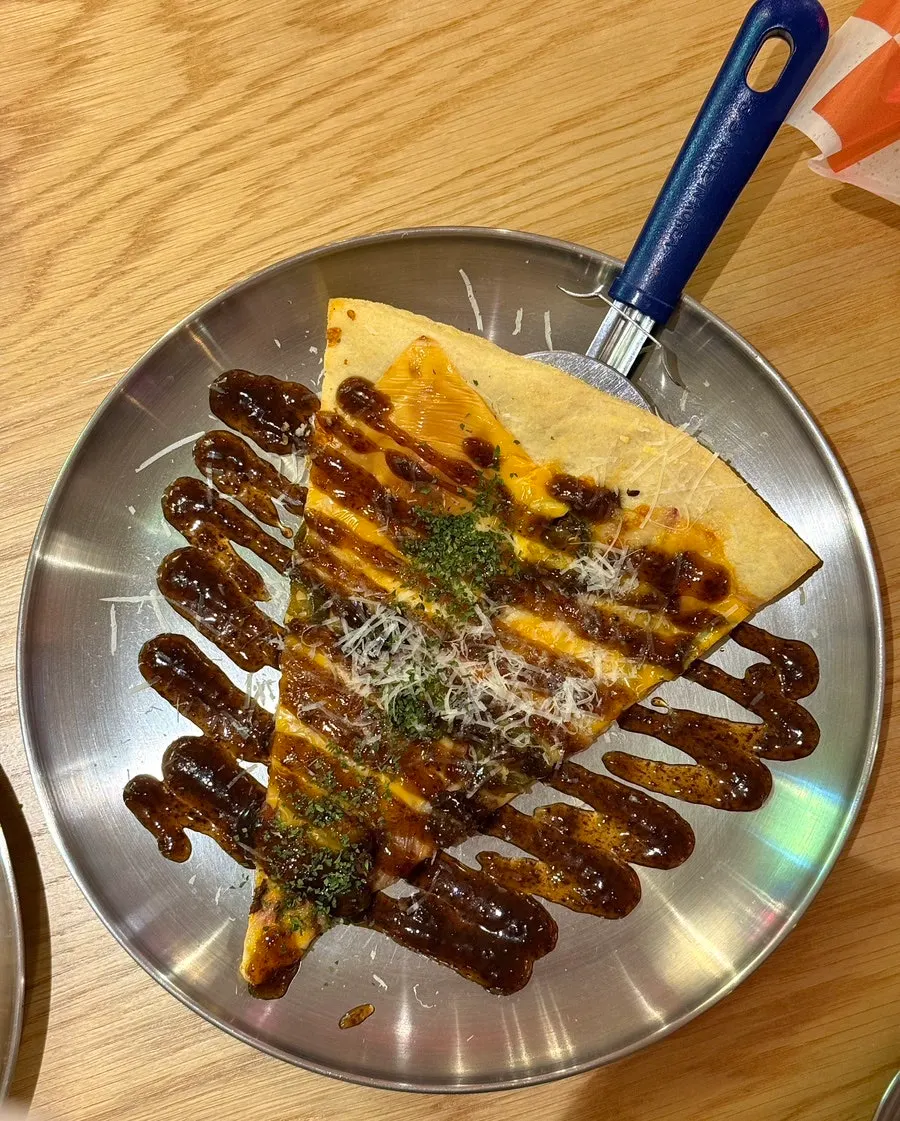 A slice of Big American Bulbeok Pizza